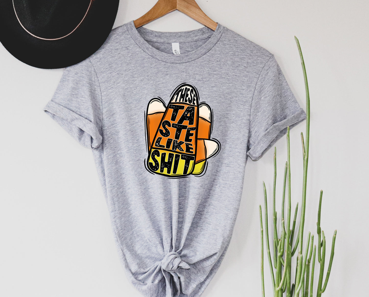 Wholesale Candy Corn Tastes Like Sh*t Graphic Tee - Sand